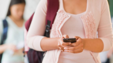 Female student texting on phone