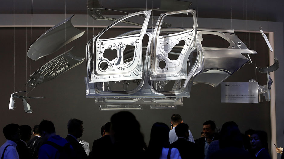 People gather at the Nio booth, at the Shanghai Auto Show, during its media day, in Shanghai, China April 19, 2017.